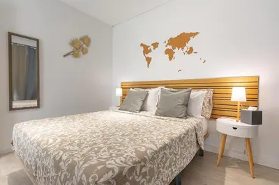 a bedroom with a large bed with a wooden headboard at gate15 in Machico