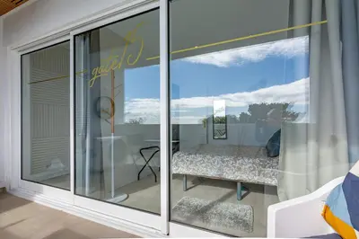 a room with a window with a bed on a balcony at gate15 in Machico