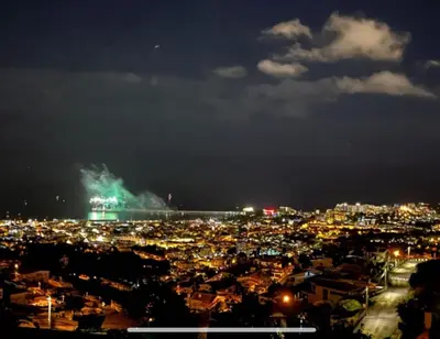 a city at night with a ship in the distance at Casa D'Avó Filó in Funchal