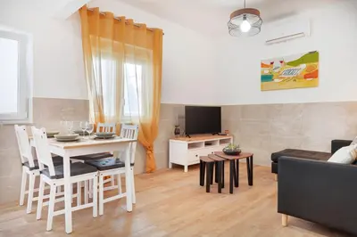 a living room with a table and a couch at Casa Cintra in Almádena