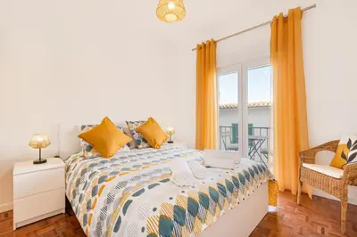 a bedroom with a bed and a window at Casa Cintra in Almádena
