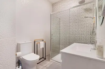 a bathroom with a toilet and a shower and a sink at Casa Cintra in Almádena