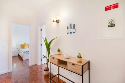 a living room with a table and a bed in a room at Casa Cintra in Almádena