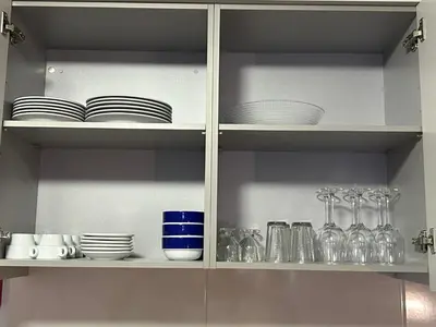 a kitchen shelf with plates and glasses and dishes at Vila Pico da Torre Apartment in Câmara de Lobos