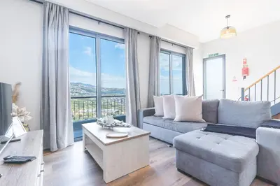 a view of a city and the ocean from a building at Figueiras House by Atlantic Holiday in Câmara de Lobos