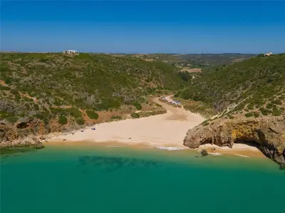 an aerial view of a beach with green water at Casa da Figueira - Guest House in Figueira