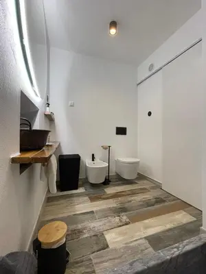 a bathroom with two sinks and two toilets at Casa da Figueira - Guest House in Figueira