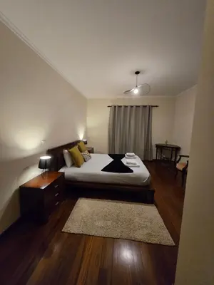 a bedroom with a bed and a rug in it at TMaria in Ponta do Sol