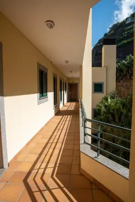 a corridor of a building with a balcony at TMaria in Ponta do Sol