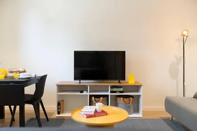 a living room with a tv and a table at Golden City by An Island Apart in Funchal