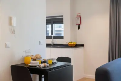 a kitchen with a table with orange juice on it at Golden City by An Island Apart in Funchal
