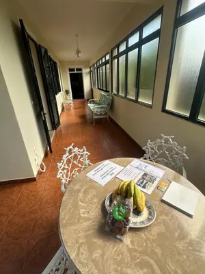 a table with a plate of bananas on it at Elisabeth House in Ponta do Sol