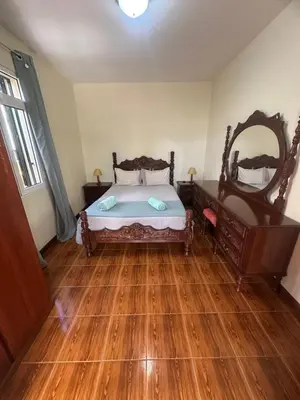a bedroom with a bed and a large mirror at Elisabeth House in Ponta do Sol