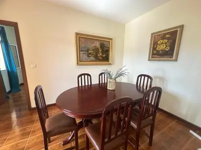 a dining room with a wooden table and chairs at Elisabeth House in Ponta do Sol