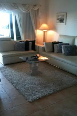a living room with a couch and a coffee table at Villa das Acacias Praia da Luz beautiful 3 bedroom villa with sea views in Luz