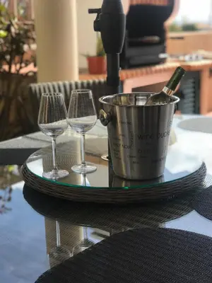 two wine glasses and a bucket with a bottle of wine at Villa das Acacias Praia da Luz beautiful 3 bedroom villa with sea views in Luz