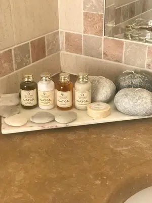 a shelf with jars and rocks on a counter at Villa das Acacias Praia da Luz beautiful 3 bedroom villa with sea views in Luz