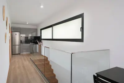 a staircase in a house with a large window at Germana House by An Island Apart in Ponta do Sol