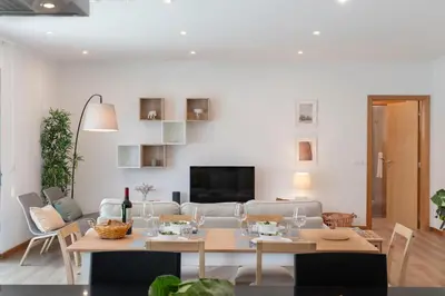 a living room with a table and a couch at Germana House by An Island Apart in Ponta do Sol