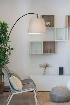 a living room with a chair and a lamp at Germana House by An Island Apart in Ponta do Sol