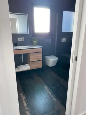 a bathroom with a sink and a toilet at B&B Camacha Porto Santo in Porto Santo