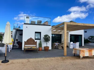 a house with a glass roof with a patio at B&B Camacha Porto Santo in Porto Santo