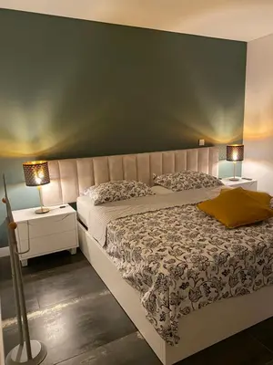 a bedroom with a large bed and two lamps at B&B Camacha Porto Santo in Porto Santo