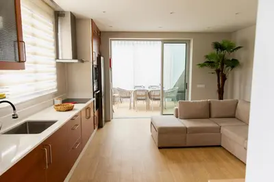 a kitchen with a couch and a living room at HOMELIKE FUNCHAL I in Funchal
