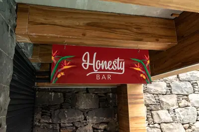 a sign for a bar on top of a stone wall at HOMELIKE FUNCHAL I in Funchal