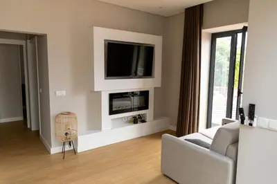 a living room with a tv and a couch and a chair at HOMELIKE FUNCHAL II in Funchal