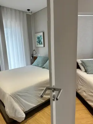 a bedroom with two beds and a door open at HOMELIKE FUNCHAL II in Funchal