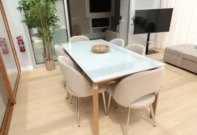 a white dining table and chairs in a living room at HOMELIKE FUNCHAL II in Funchal