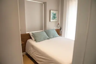 a bedroom with a bed with two pillows on it at HOMELIKE FUNCHAL II in Funchal