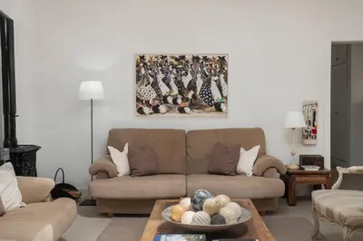 a living room with a couch and a painting on the wall at Casa de Férias by An Island Apart in Porto Santo