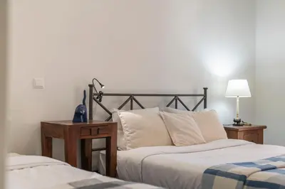 a bedroom with two beds and a lamp at Casa de Férias by An Island Apart in Porto Santo
