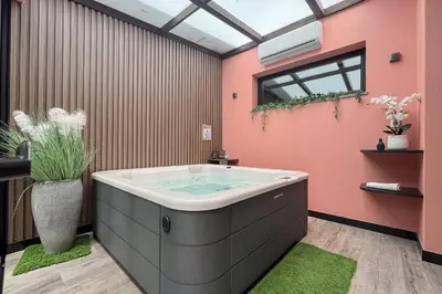 a bathroom with a large tub in the middle of the room at Casa Requinte - Jacuzzi in Arco da Calheta