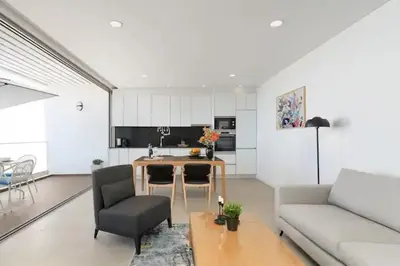 a living room with a couch and a table at Dália modern apartment Five minutes to beach in Luz