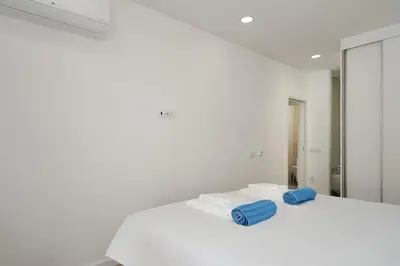 a white room with two towels and a mirror at Dália modern apartment Five minutes to beach in Luz