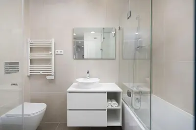 a white bathroom with a toilet sink and a shower at Dália modern apartment Five minutes to beach in Luz