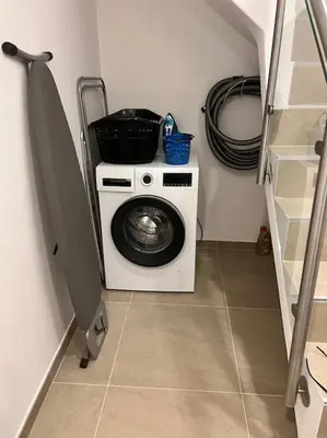 a washer and dryer in a small room at Dália modern apartment Five minutes to beach in Luz