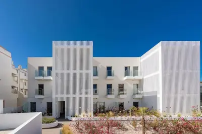 two tall white buildings next to each other at Dália modern apartment Five minutes to beach in Luz