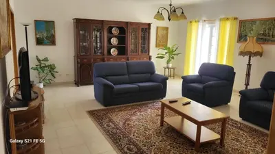 a living room with two blue chairs and a coffee table at Casa Estêvão in Aljezur
