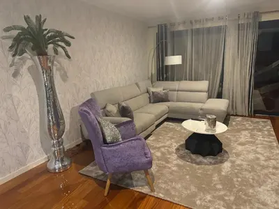 a living room with a couch and a purple chair at Casared in Funchal