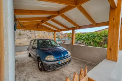 a small blue car parked inside of a house at Cantinho da Portada in Seixal