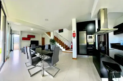a dining room and kitchen with a table and chairs at Sal e Pimenta House - A Wellbeing Retreat in Machico