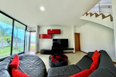 a living room with a couch and a tv at Sal e Pimenta House - A Wellbeing Retreat in Machico