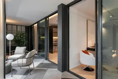 a room with sliding glass doors and white chairs at Savoy Insular II by An Island Apart in Funchal