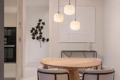 a dining room with a wooden table and chairs at Savoy Insular II by An Island Apart in Funchal
