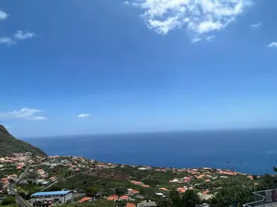 a view of a city with the ocean in the background at Villa Arco Iris in Arco da Calheta