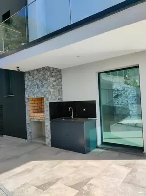 a house with a sink and a large window at Villa Arco Iris in Arco da Calheta